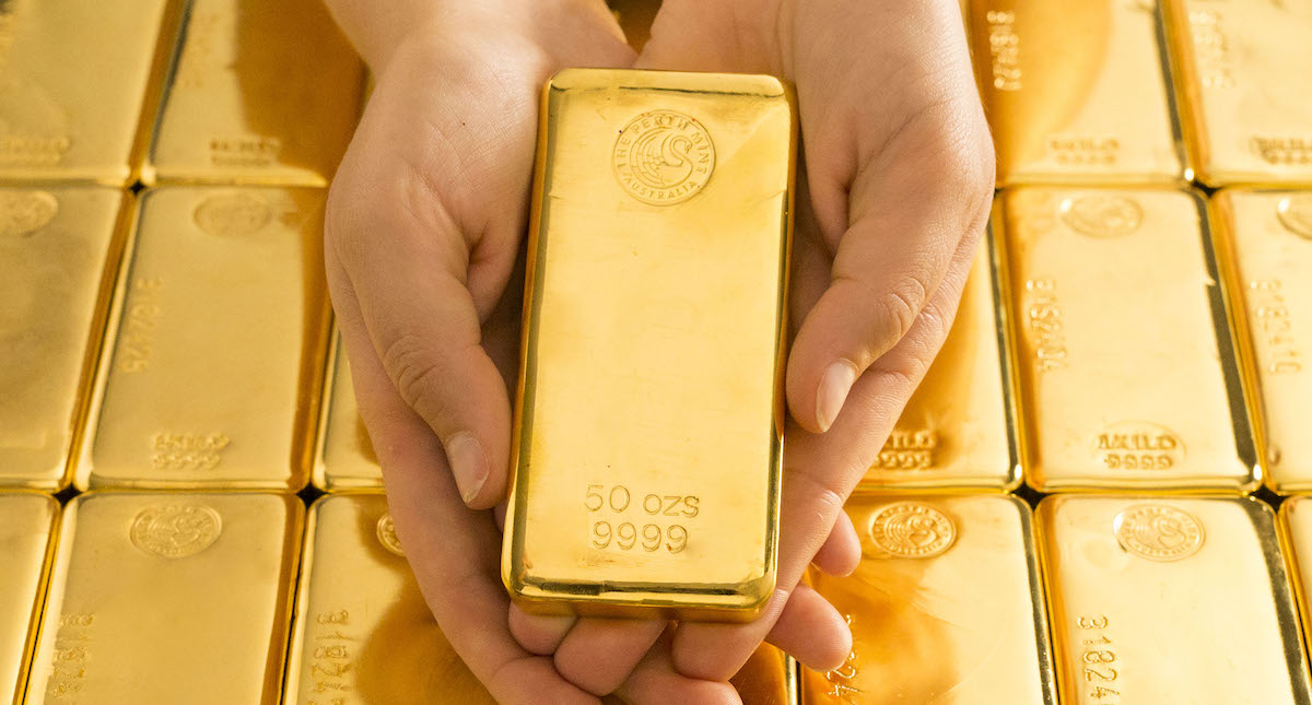 50oz gold cast bar in hands