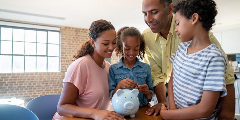 young family looking at piggy bank 0